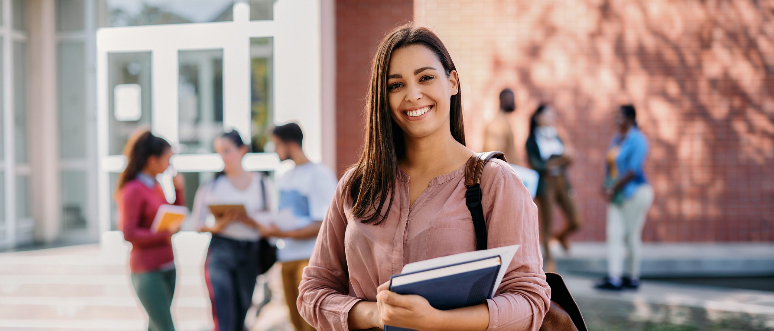 Woman holding schoolbooks