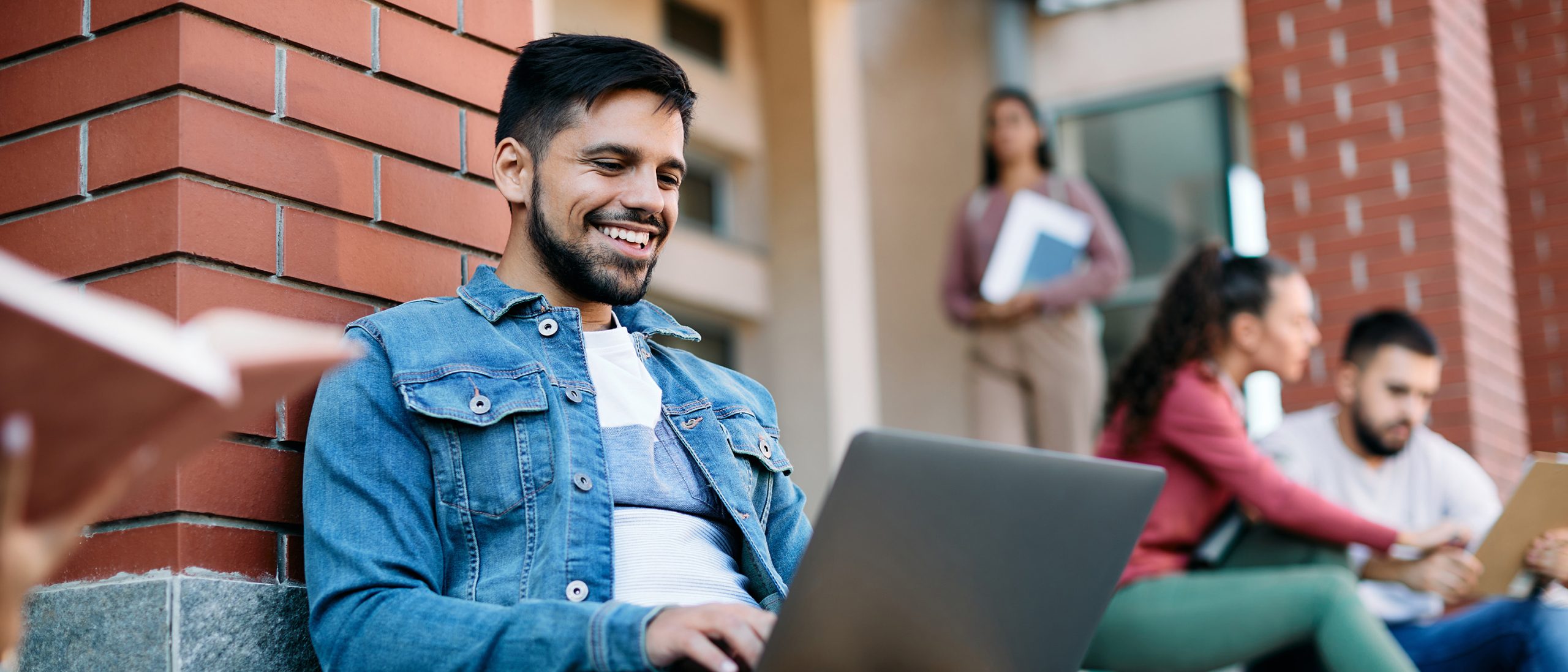 Student working on campus on his computer