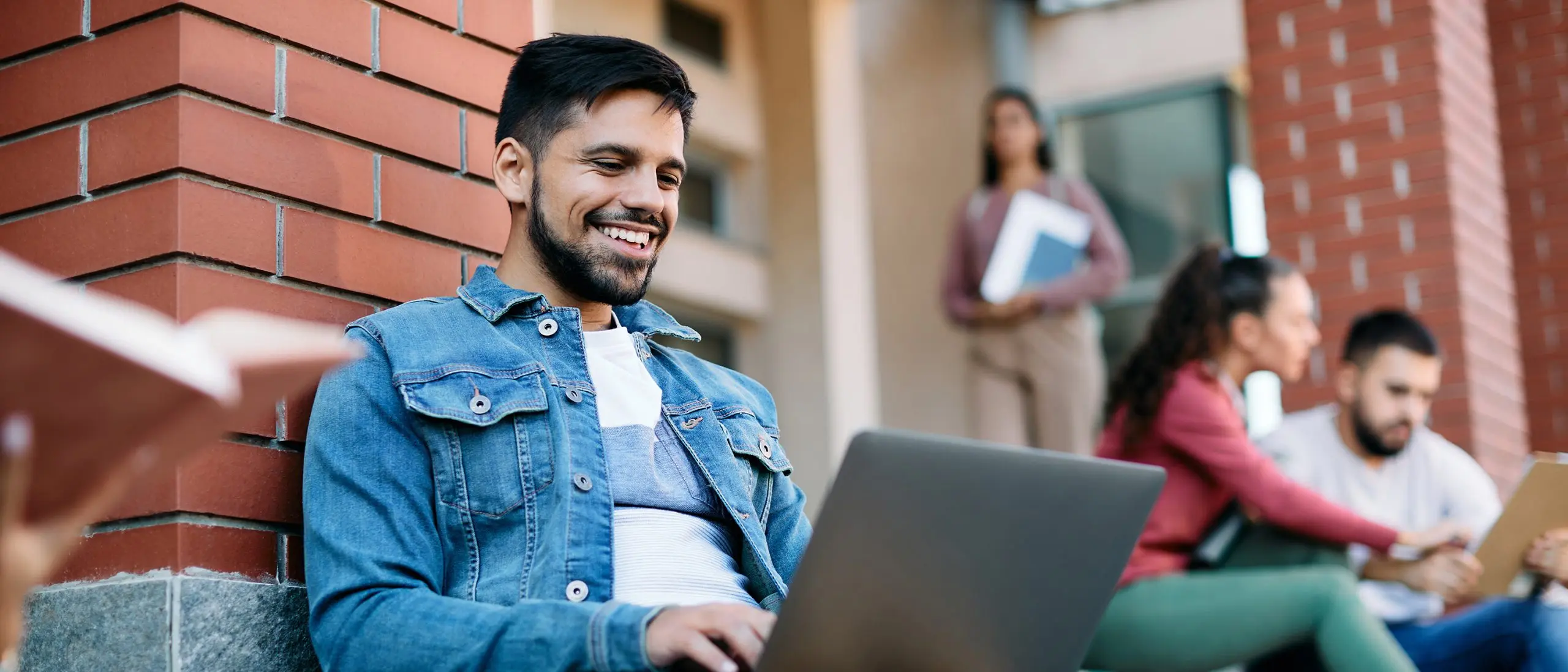 Student working on campus on his computer