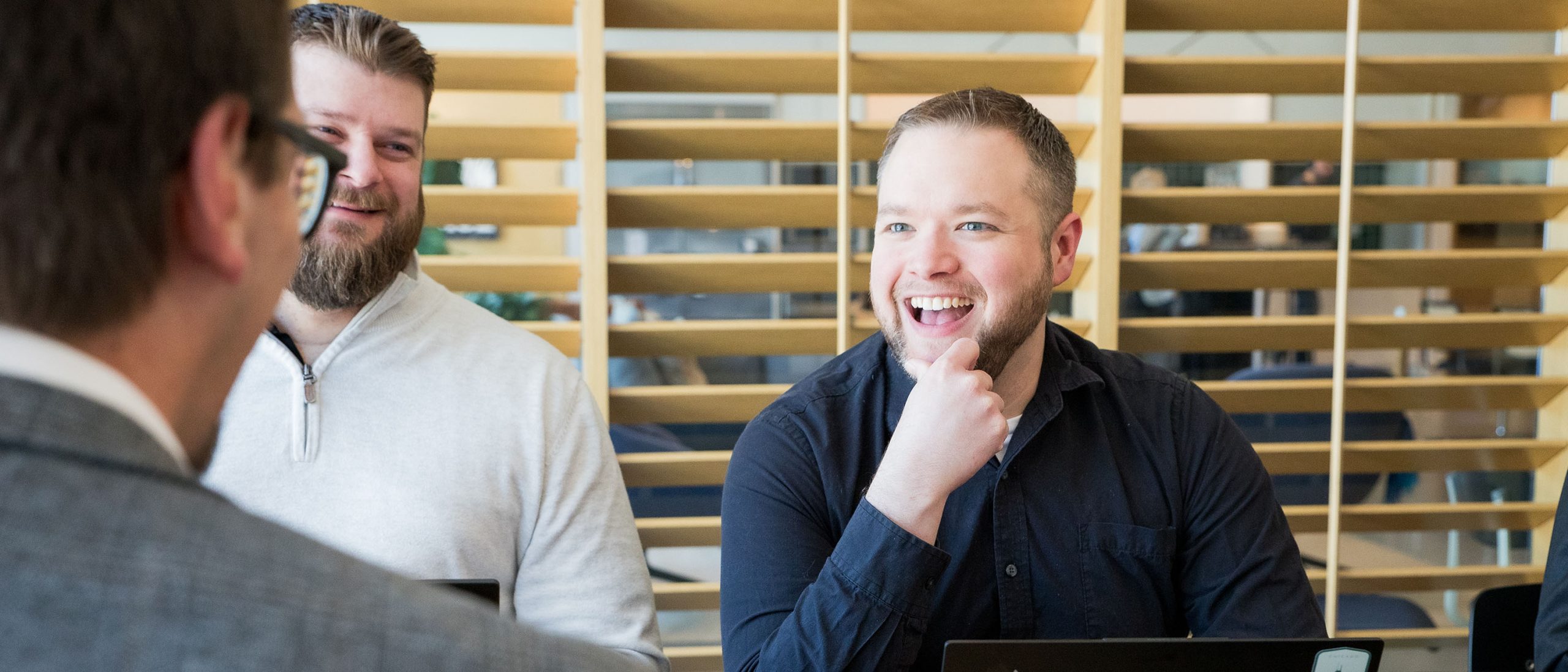 Man smiling in business meeting