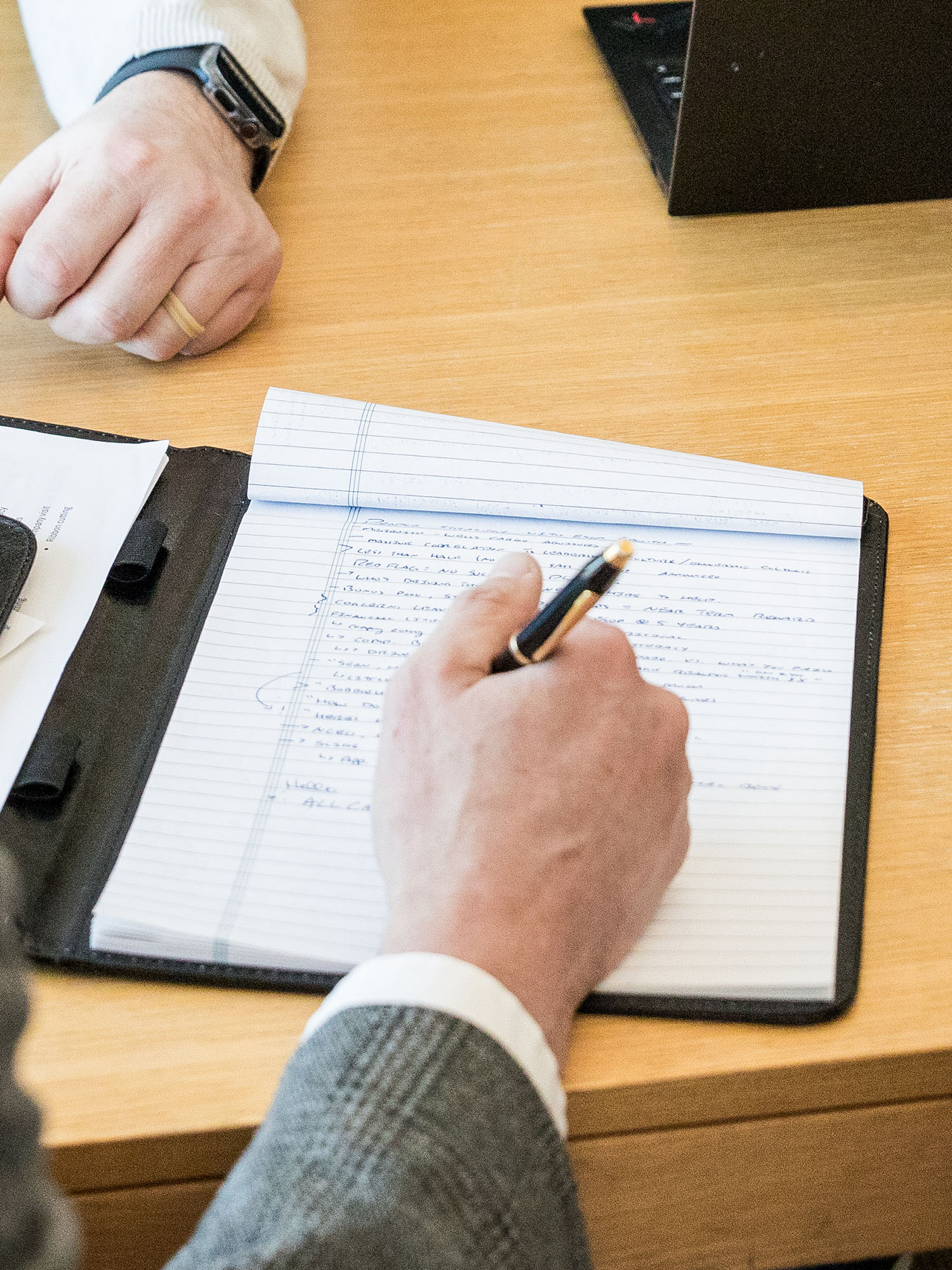 Person taking notes on a notepad