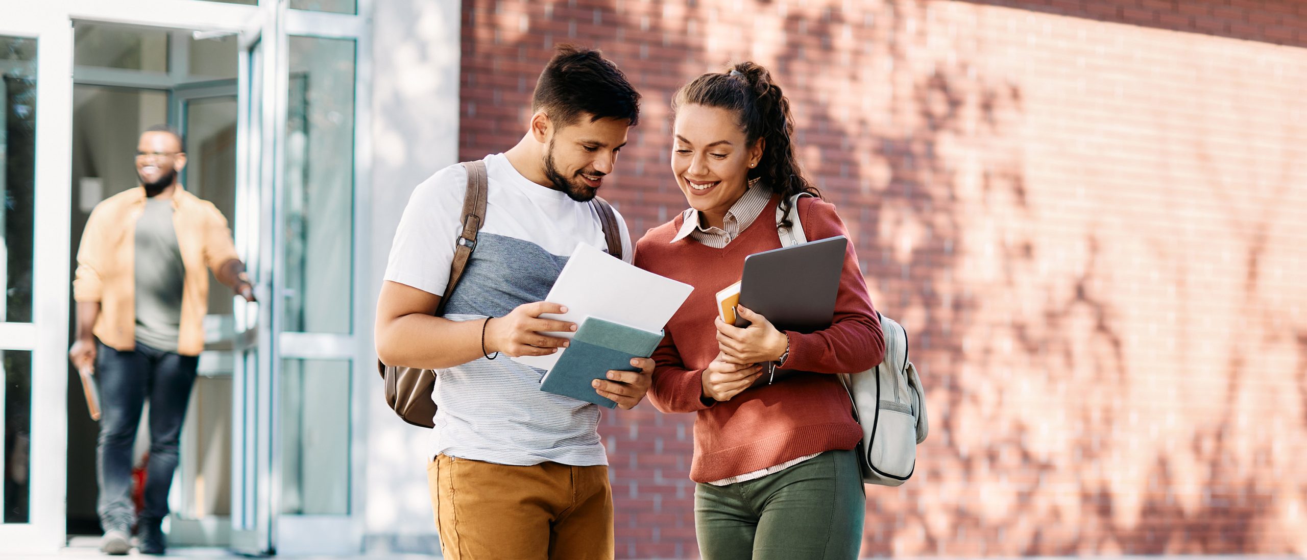 Students looking at notes on campus