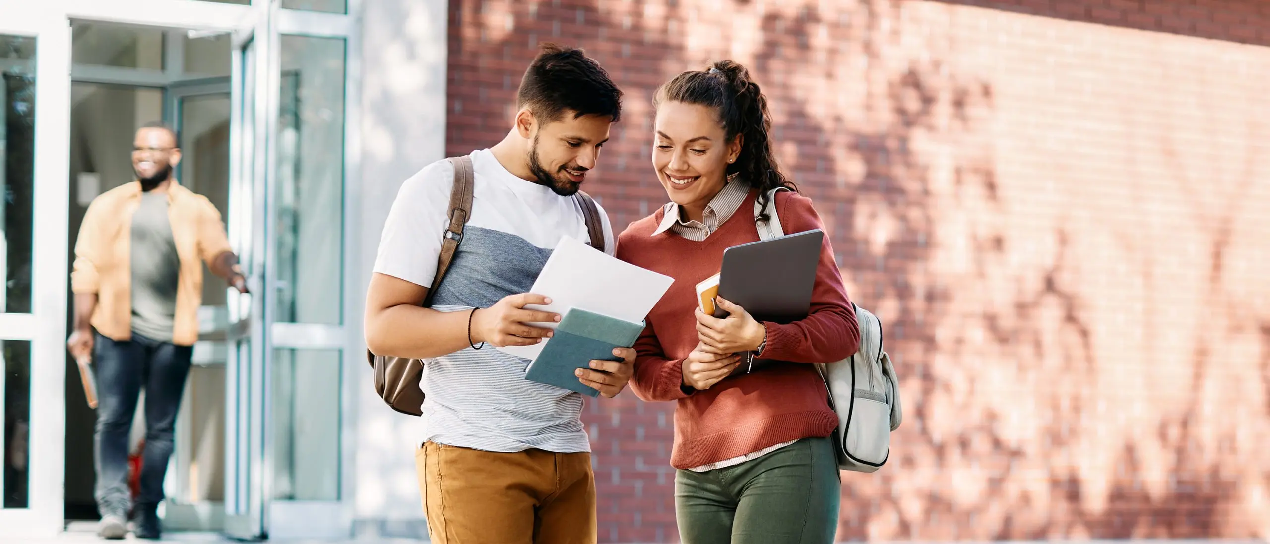Students looking at notes on campus