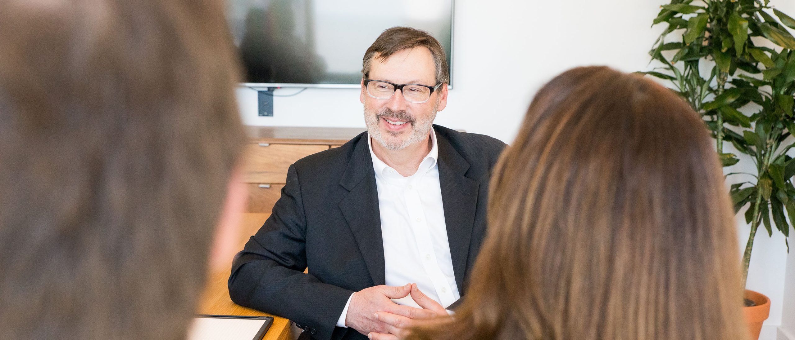 Man sitting at table talking to coworkers