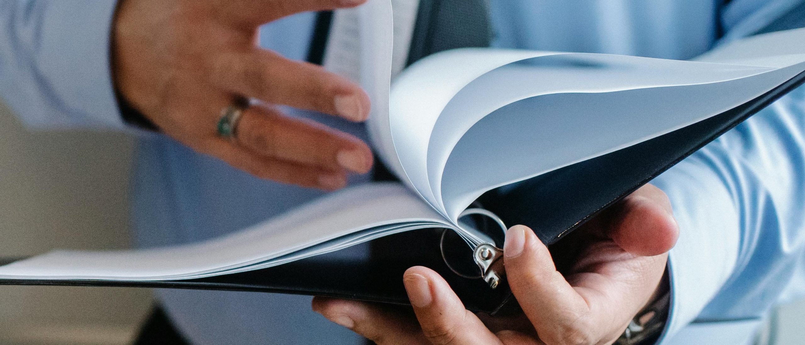 Person turning pages through bidner