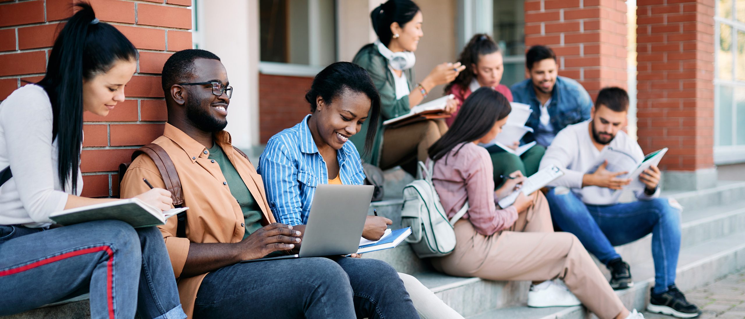 College students sitting on campus stairs