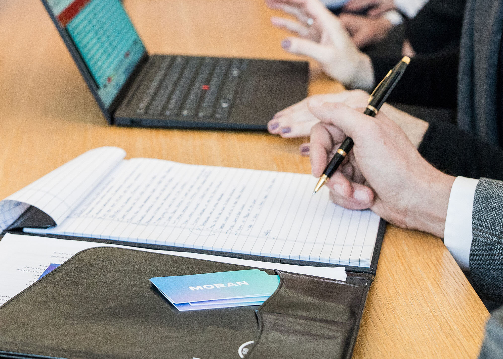 Person taking notes at meeting