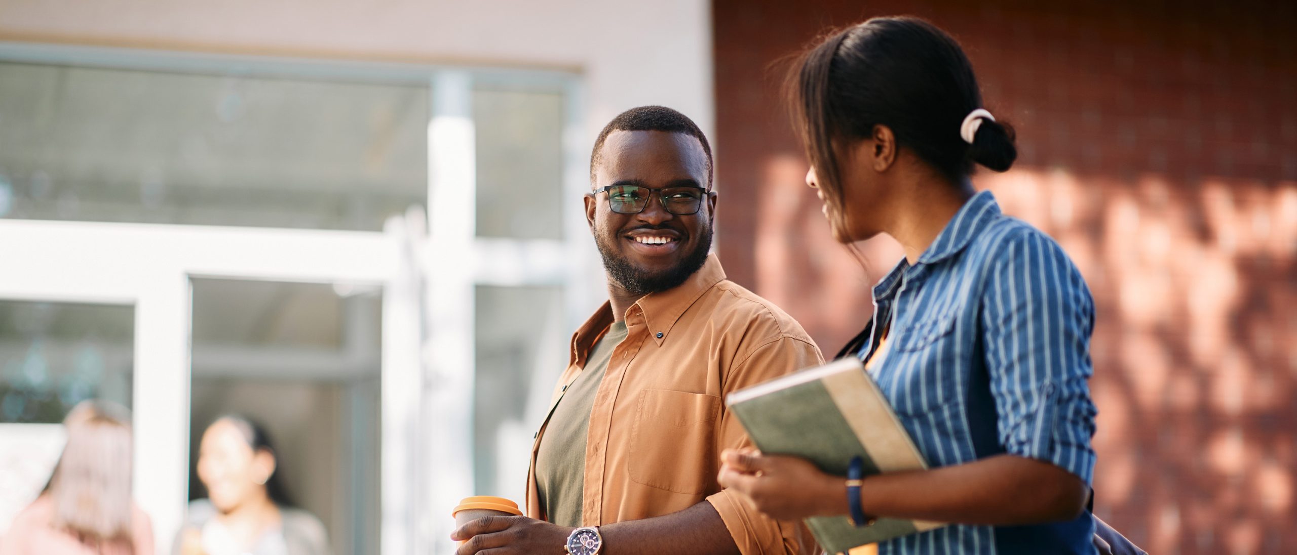 Two young adults walking in conversation