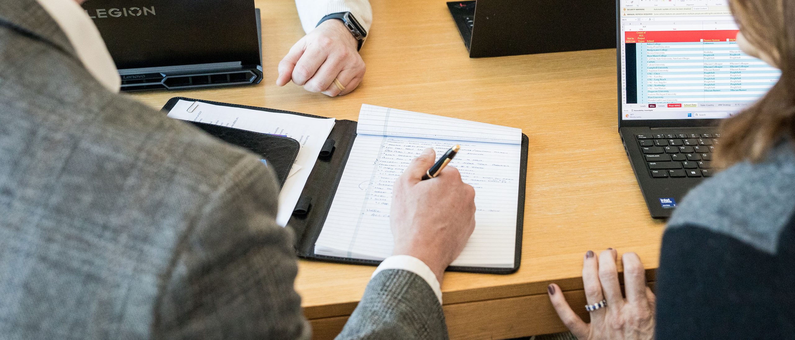 Person taking notes in meeting